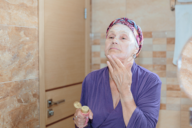 elderly-woman-taking-care-her-face.jpg